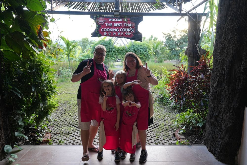 The whole Clarkson family in matching red aprons at The Best Thai Cooking Course in Chiang Mai