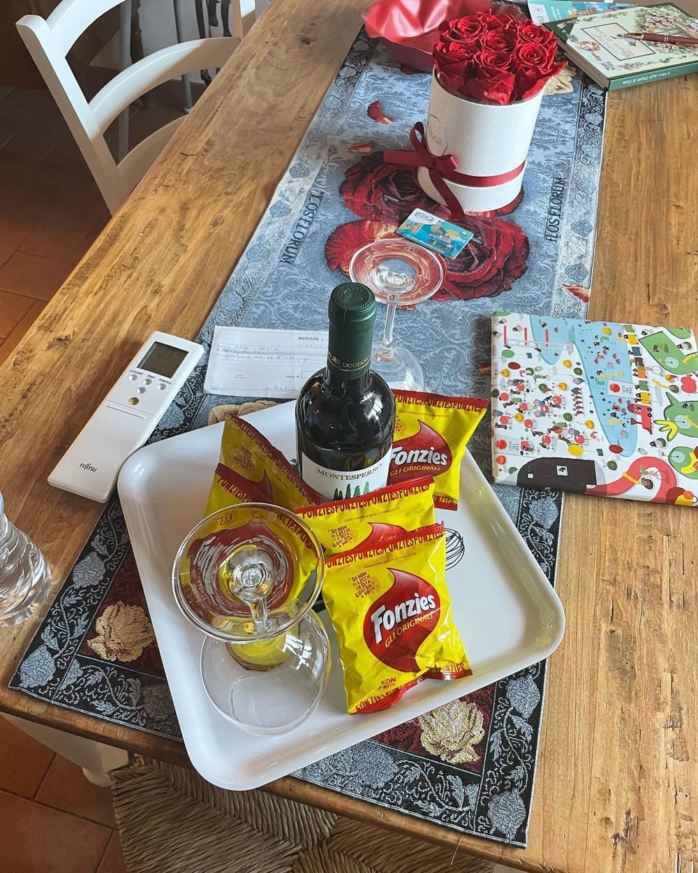 The arrival spread at Casa Aida in Lucca — birthday present for Harper, activity sets for the older girls, wine, beers, water, and snacks left by the host Anna