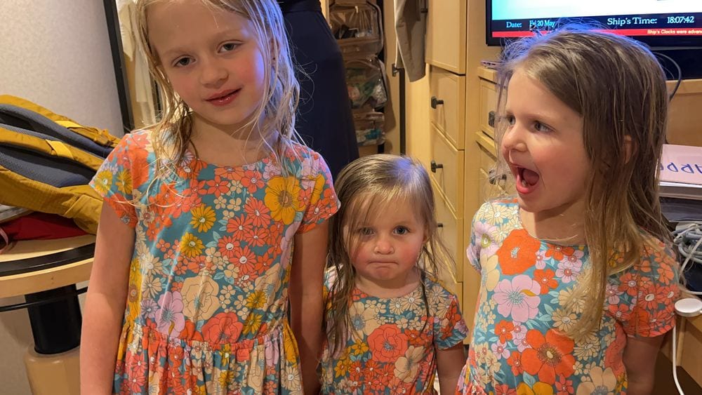Lily, Cora, and Harper in dresses with lip gloss and eye shadow before dinner on the Queen Mary 2