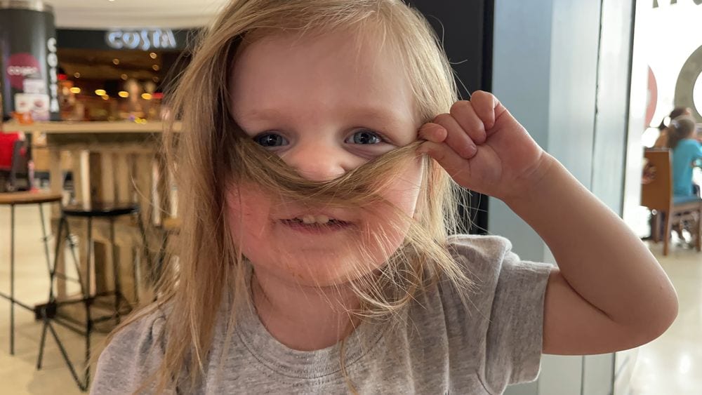 Harper using her hair as a mustache outside Costa Coffee at The Polygon mall in Southampton