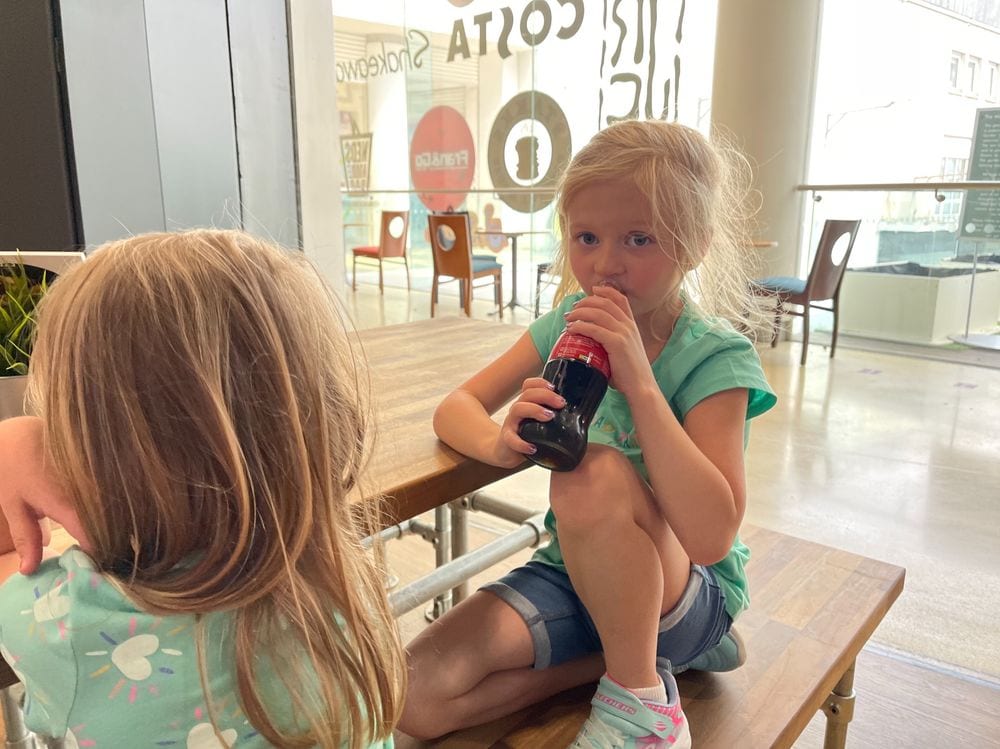 Lily and Cora sharing their first-ever Coke at The Polygon mall in Southampton